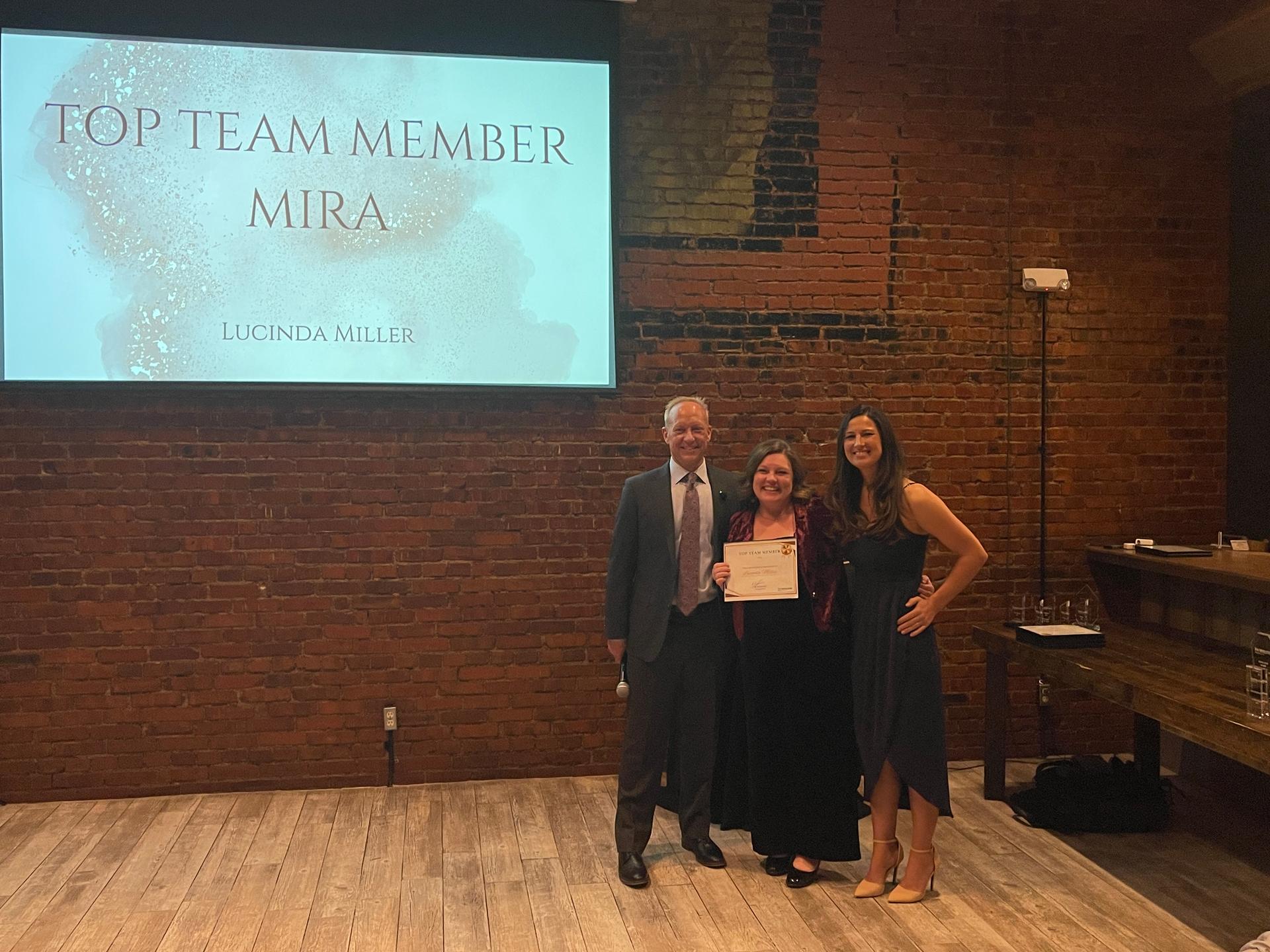 Lucinda Miller receiving a Top Team Member award